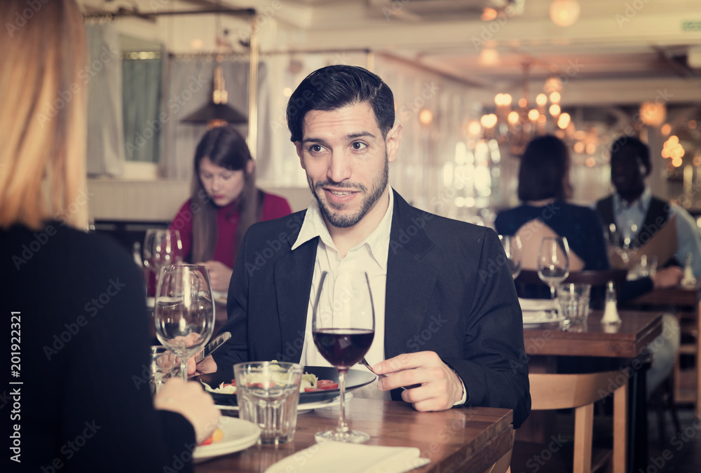 Happy man with girlfriend in restaurant
