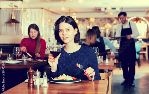 Woman enjoying dinner alone in restaurant