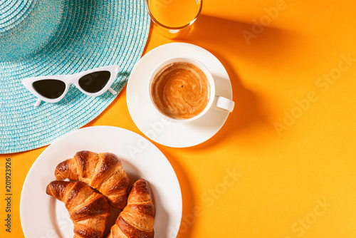 Canvas Print hat, sunglasses croissant with a cup of coffee and a glass of orange juice on a