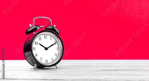 alarm clock on wooden board