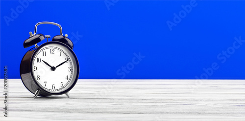 alarm clock on wooden board