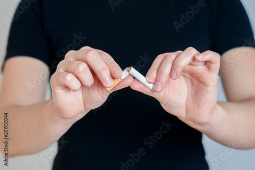 Girl breaks a cigarette. concept no Smoking