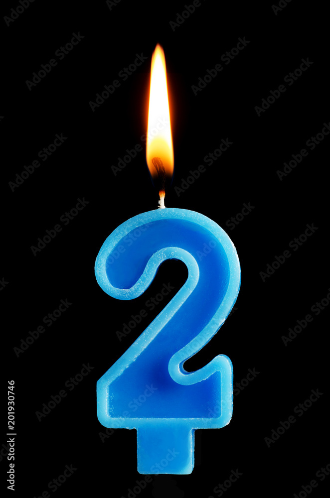 Burning birthday candle in the form of 2 two figures for cake isolated on black background. The concept of celebrating a birthday, anniversary, important date, holiday, table setting Burning birthday candle in the form of 2 two figures for cake isolated on black background. The concept of celebrating a birthday, anniversary, important date, holiday, table setting