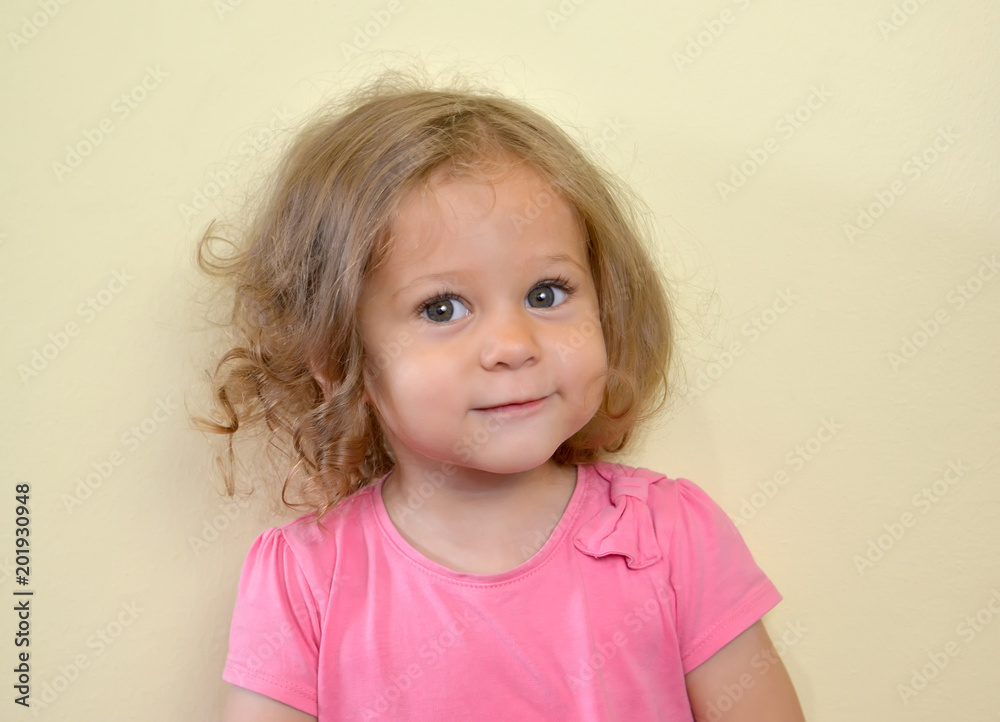 Portrait of the two-year-old girl on a light background Portrait of the two-year-old girl on a light background