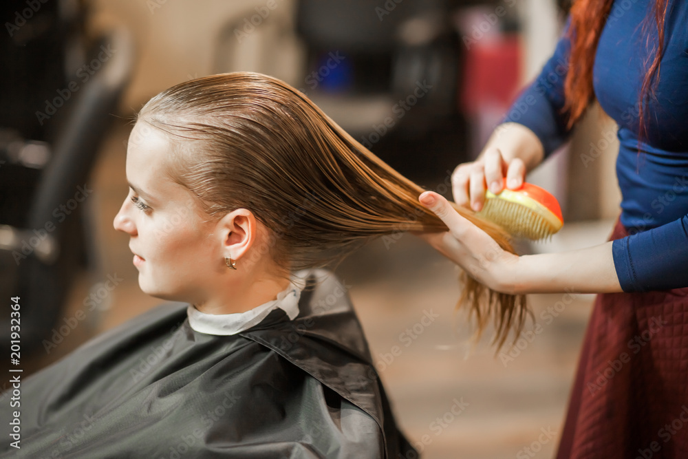 Barber Girl comb wet hair in hair salon Stock Photo | Adobe Stock
