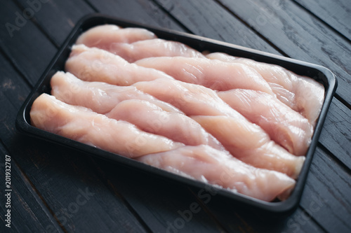 Canvas Print Fresh raw organic chicken fillet in black market box
