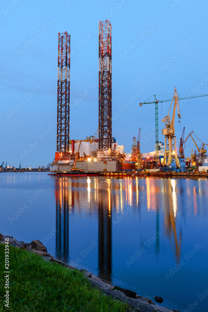 Oil rig docked in shipyard of Gdansk at dusk. Poland