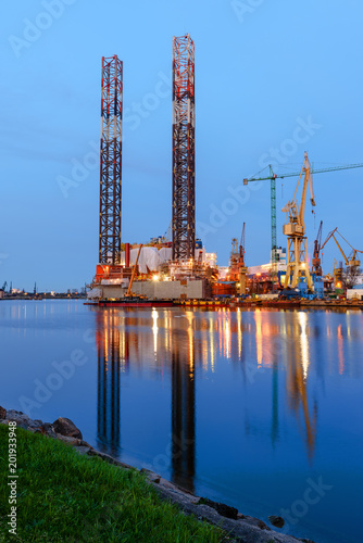 Oil rig docked in shipyard of Gdansk at dusk. Poland