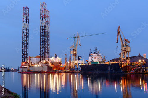 Oil rig docked in shipyard of Gdansk at dusk. Poland