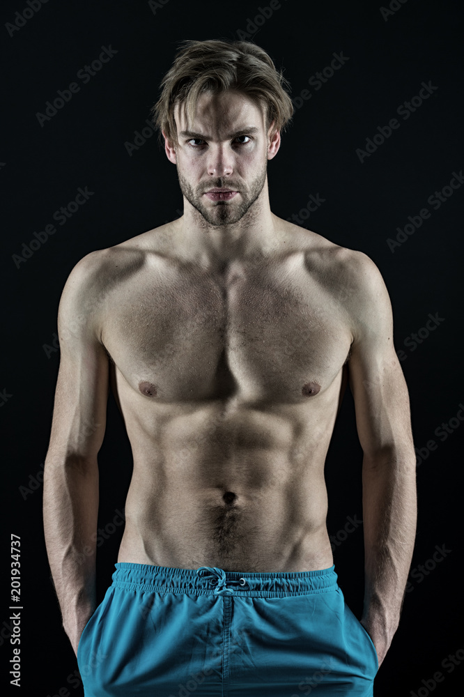 Fototapeta premium Macho with sexy torso and chest. Man bodybuilder with fit body. Sportsman with six pack and ab muscles. Training and workout activity in gym. Sport fitness and bodycare concept, vintage
