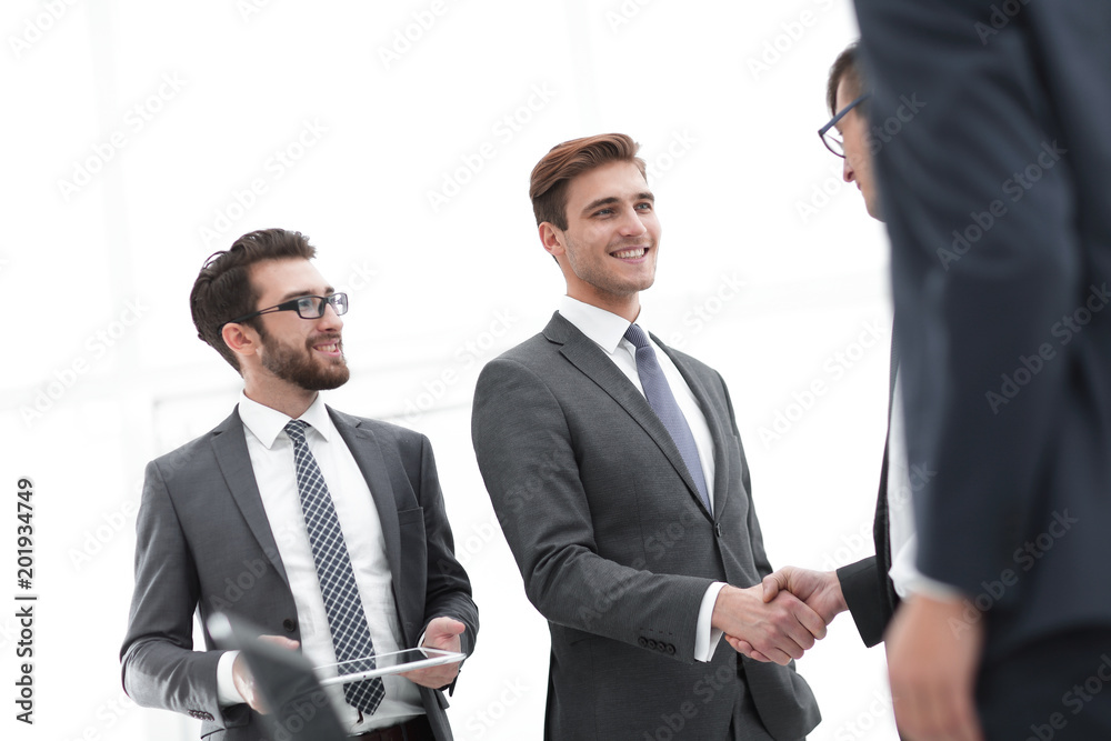 Two cheerful businessmen shaking hands with smile at office with Two cheerful businessmen shaking hands with smile at office with
