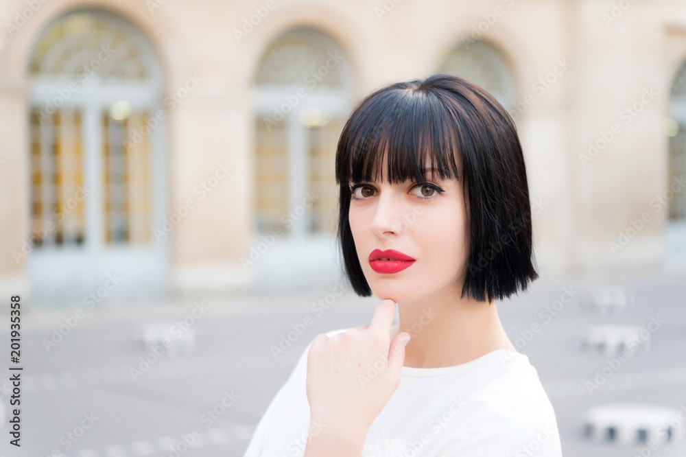 Woman with brunette hair and red lips makeup face in Paris, France Woman with brunette hair and red lips makeup face in Paris, France
