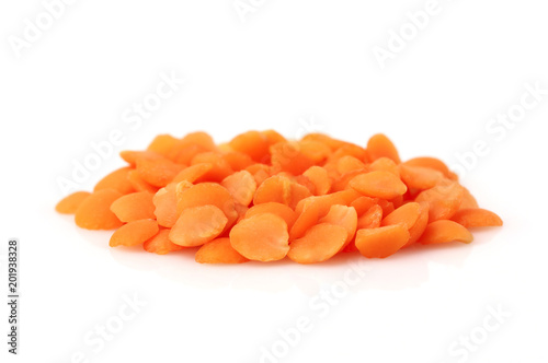 Heap of raw red lentils isolated.