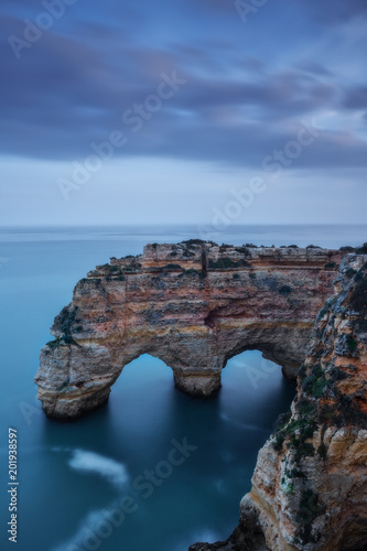 Mountains and arches in the shape of a heart on the beach Marinha.