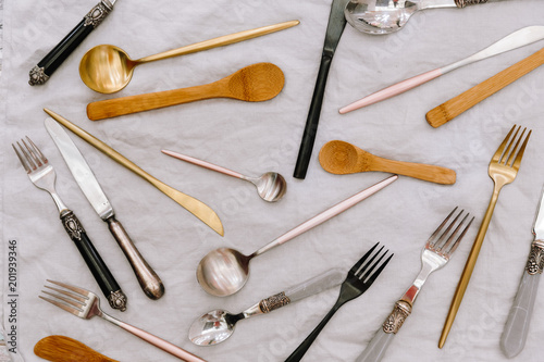 Flat lay set of cutlery. Silverware over linen tablecloth