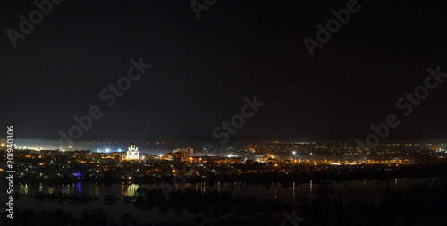 Night cityscape photographed from above. River flood in the spring. Panoramic view of the starry space. © olgapkurguzova