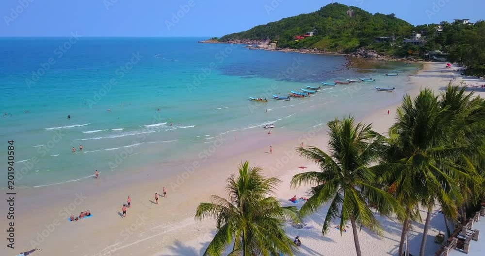People enjoy summer time,group of long tail boats slowly moving on water at sandy beach of Thailand, koh Phangan island, Haad Rin beach line view.Static video People enjoy summer time,group of long tail boats slowly moving on water at sandy beach of Thailand, koh Phangan island, Haad Rin beach line view.Static video