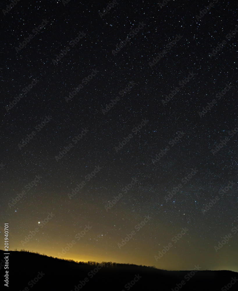 The stars in the night sky. A view of the starry space background sunset illuminated the horizon. The stars in the night sky. A view of the starry space background sunset illuminated the horizon.