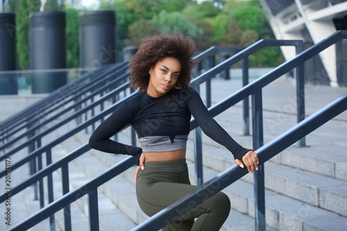 Beautiful African American woman in sportswear outdoors