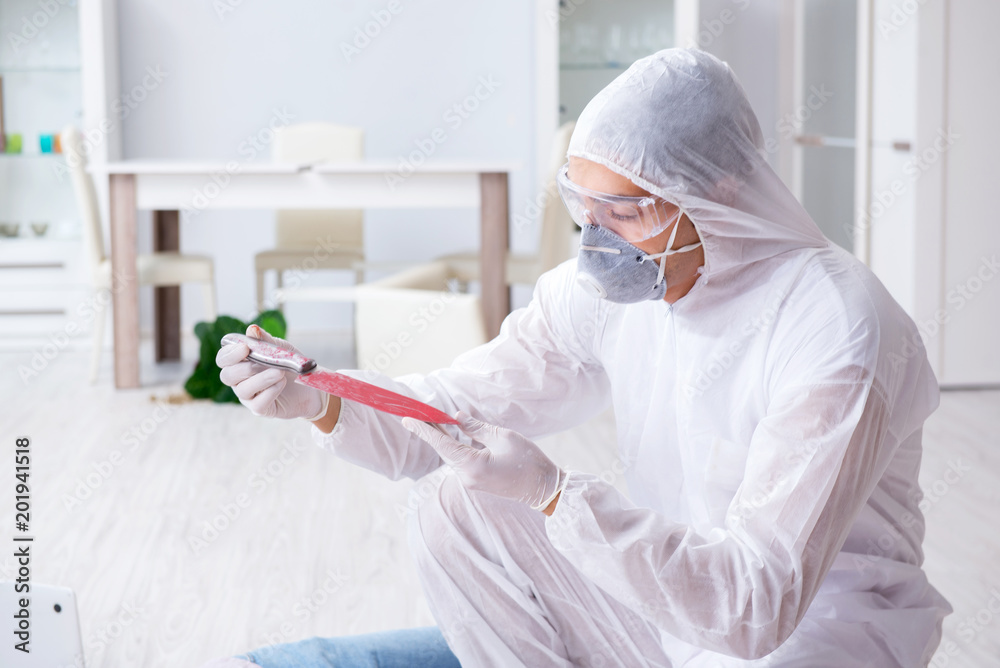 Forensic investigator at the crime scene investigating woman mur Forensic investigator at the crime scene investigating woman mur