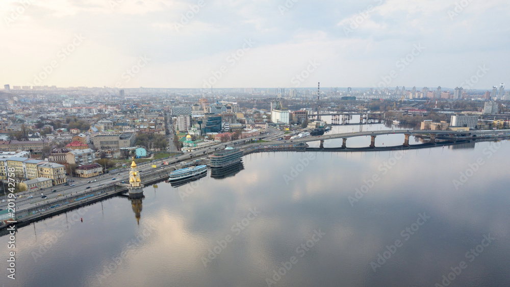 Panorama of the Dnieper embankment, Havanskyi bridge and the church of St. Nicholas on the water in Kyiv, Ukraine.