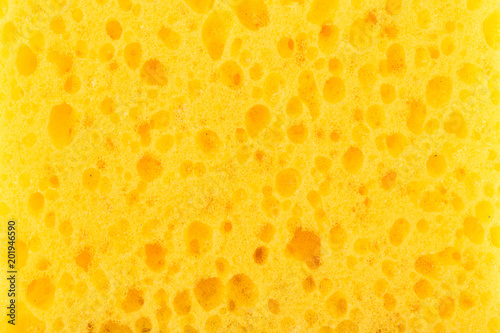 texture yellow foam rubber, synthetic sponge with large pores, close-up background