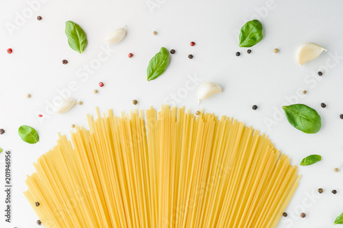 Concept food with pasta, basil, garlic and pepper on a white background