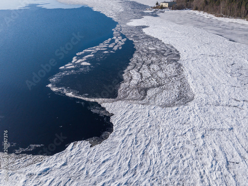 Wallpaper Mural   Aerial view of the shoreline of the lake and pieces of melting ice along the shore Torontodigital.ca