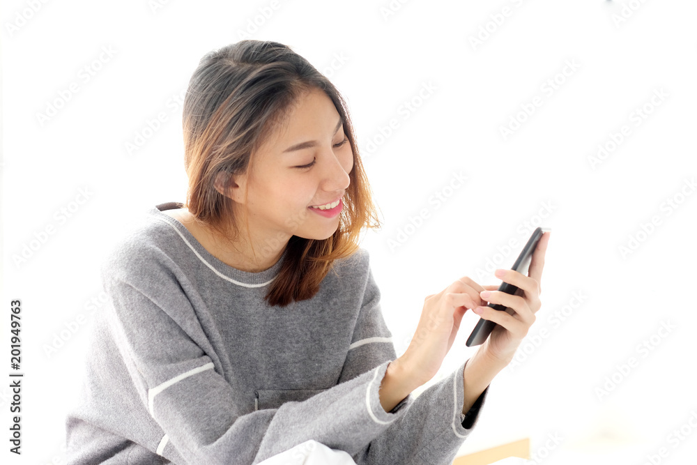 Young asian woman using smart phone with relax emotion on white background, people on phone, lifestyle Young asian woman using smart phone with relax emotion on white background, people on phone, lifestyle