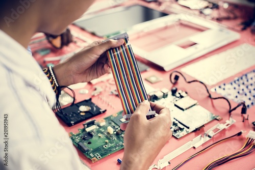 Technician holding flexible flat cable at workshop photo