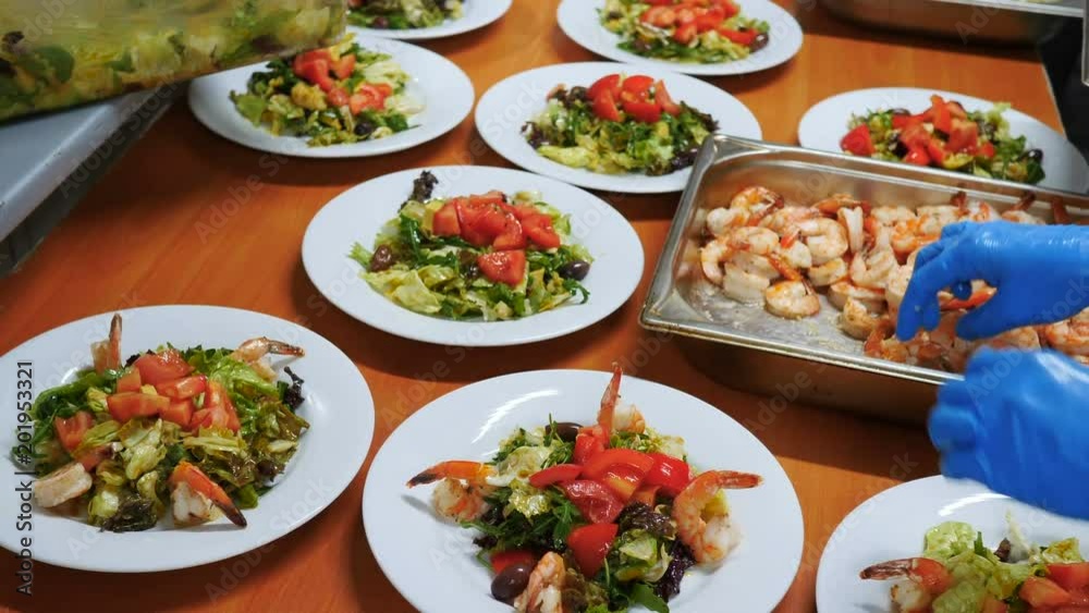 Fresh salad with avocado, cheese and tomatoes and olives and prawns are prepared Fresh salad with avocado, cheese and tomatoes and olives and prawns are prepared