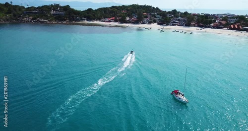 Thai taxi boat arrived at Haad Rin beach line, koh Phangan island,Thailand photo