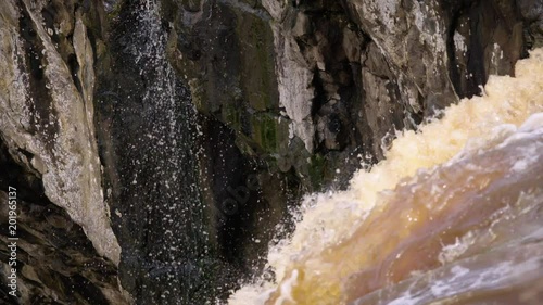 Slow motion medium shot of water running over rocks at Wannon Falls waterfalls in Hamilton, Victoria, Australia. photo