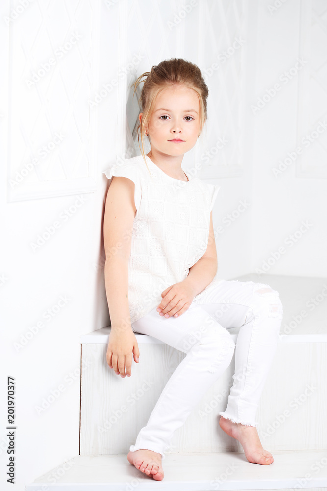 Children's fashion. Beautiful pensive serious blonde girl Children's fashion. Beautiful pensive serious blonde girl