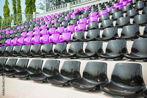 Many chairs in a soccer stadium.