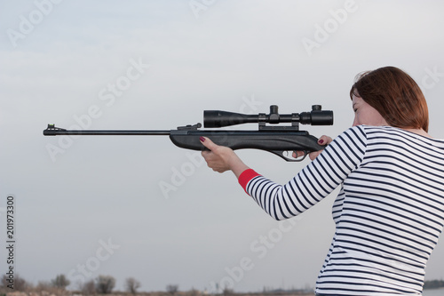 Konstfotografi Portrait of middle aged woman with rifle