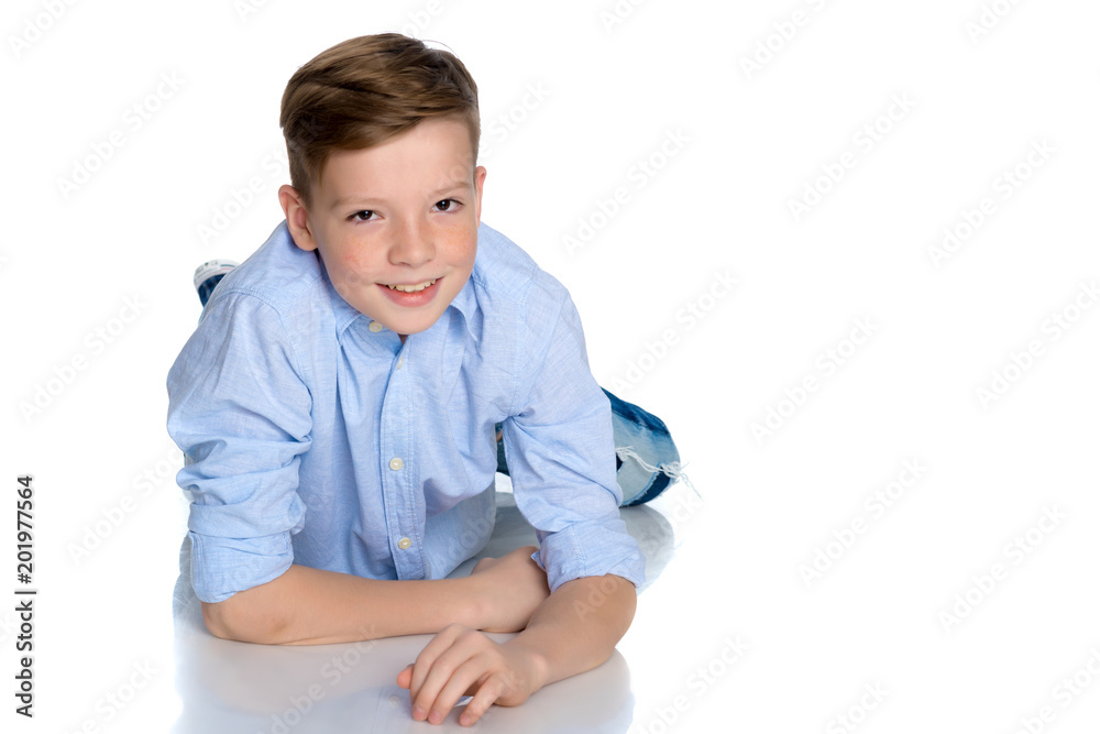 A teenager boy lies on a white background. A teenager boy lies on a white background.