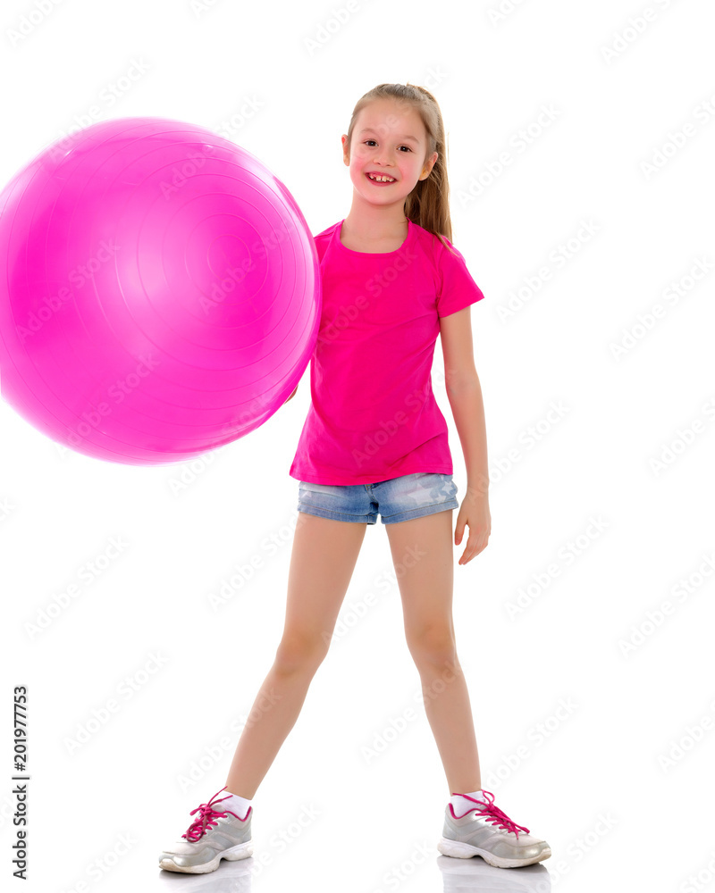 little girl doing exercises on a big ball for fitness. little girl doing exercises on a big ball for fitness.