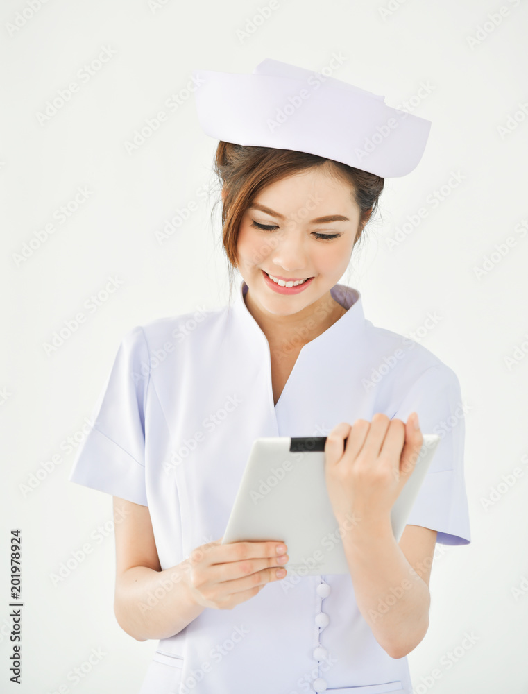 Asian nurse is smiling and holding digital tablet. Asian nurse is smiling and holding digital tablet.