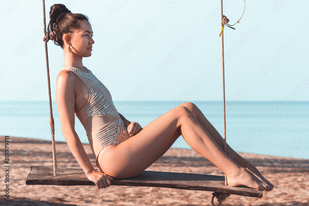 Φωτογραφία Beautiful young woman wearing a swimsuit on a swing in Koh Lanta, Krabi, Thailan