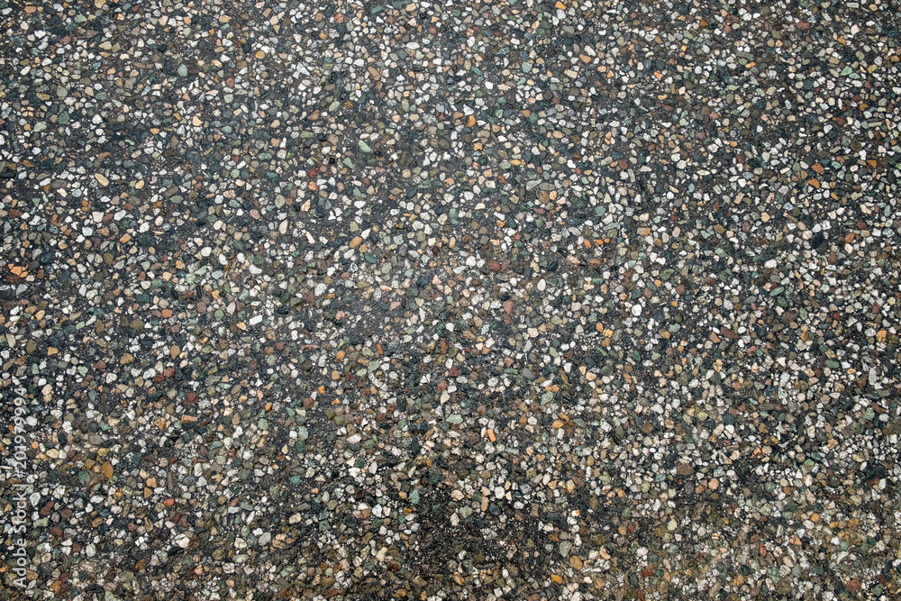 texture of the stones in the asphalt surface background texture of the stones in the asphalt surface background
