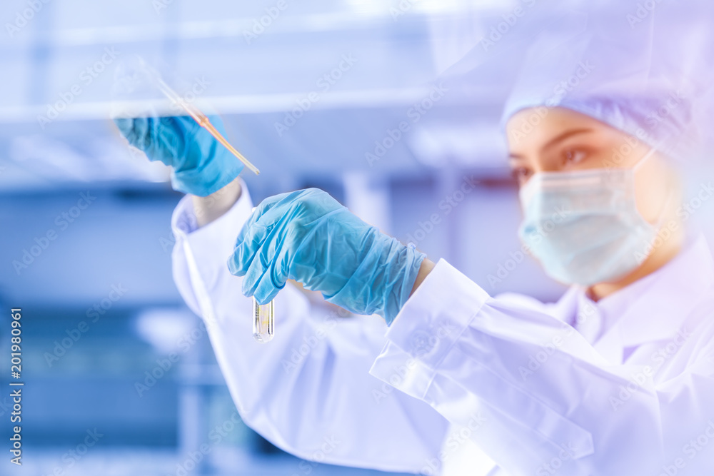 Fototapeta premium Young female scientist working in laboratory