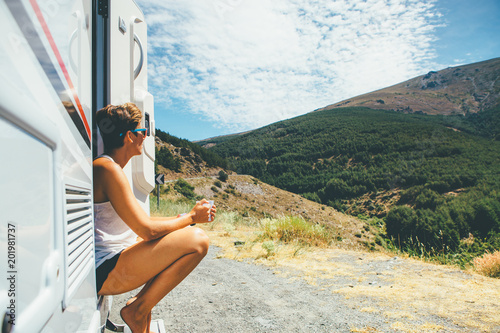 Girl sits on a motor home step