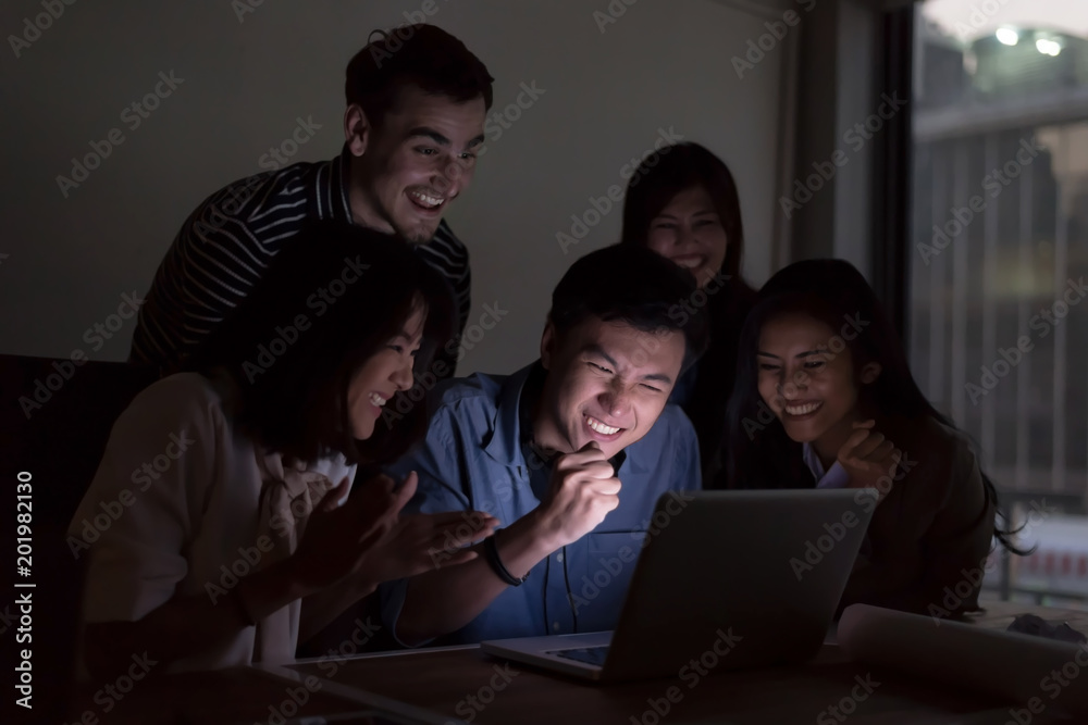 Smiling businesspeople are working with laptop overtime late at nitgh. They are using laptop to search data. Setup studio shooting. Smiling businesspeople are working with laptop overtime late at nitgh. They are using laptop to search data. Setup studio shooting.