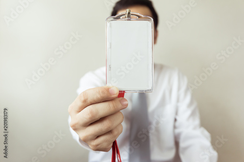 Man holding Identification card.