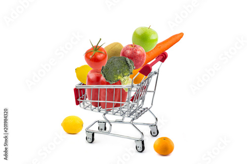 Shopping cart with fruits and vegetables on isolated white background
