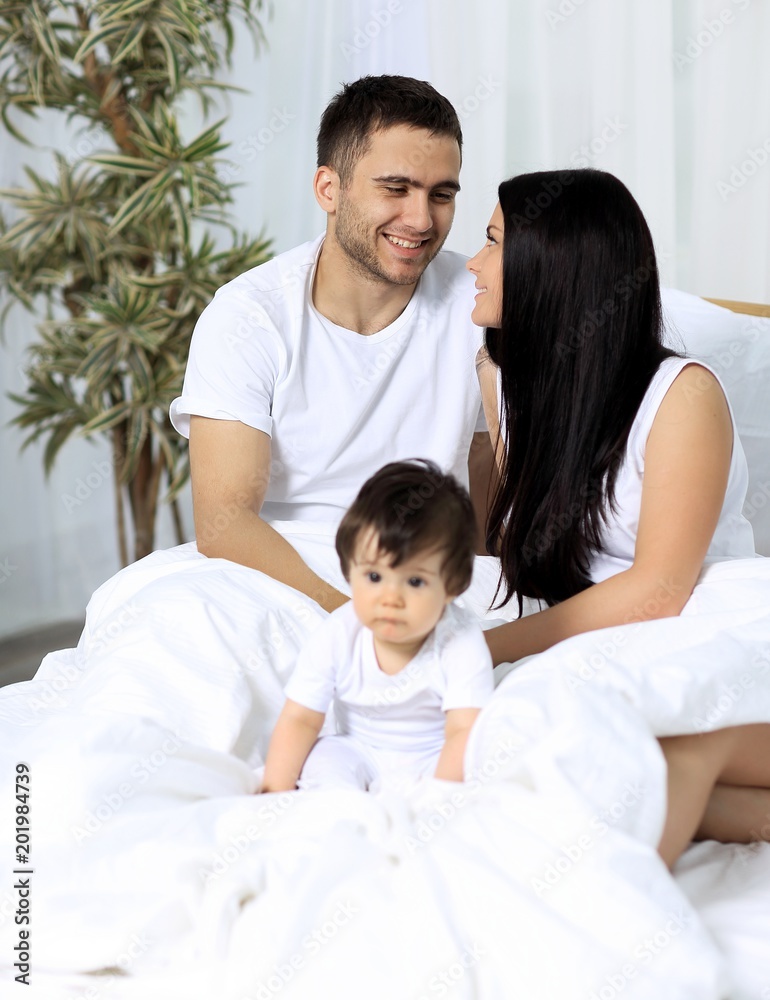 A happy young family from three persons