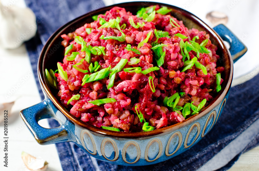 Buckwheat stewed with beetroot in a bowl on a wooden table Buckwheat stewed with beetroot in a bowl on a wooden table
