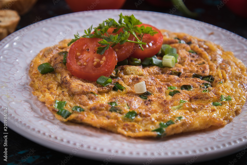 Omelet, fried chicken eggs with fresh vegetables