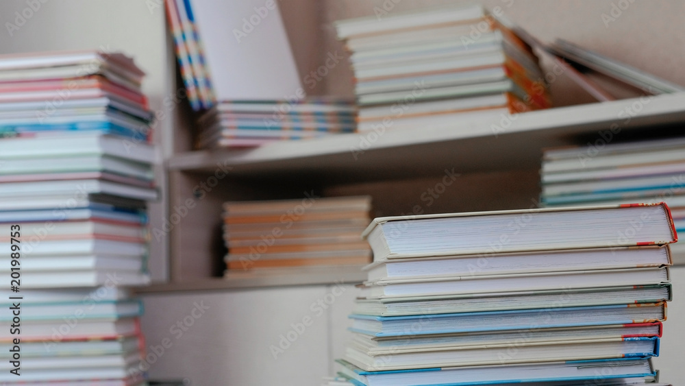 Pile of books on the floor and on the closet. Pile of books on the floor and on the closet.
